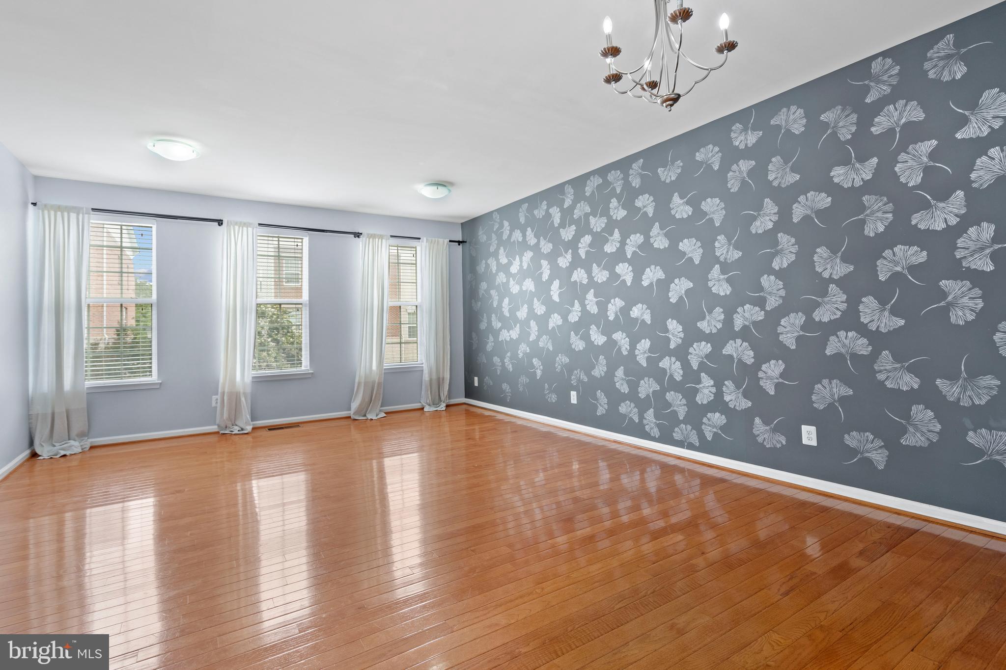 22667 Flowing Spring Square Brambleton, VA 20148 - Photo 39 of 39 a view of an empty room with a window and wooden floor