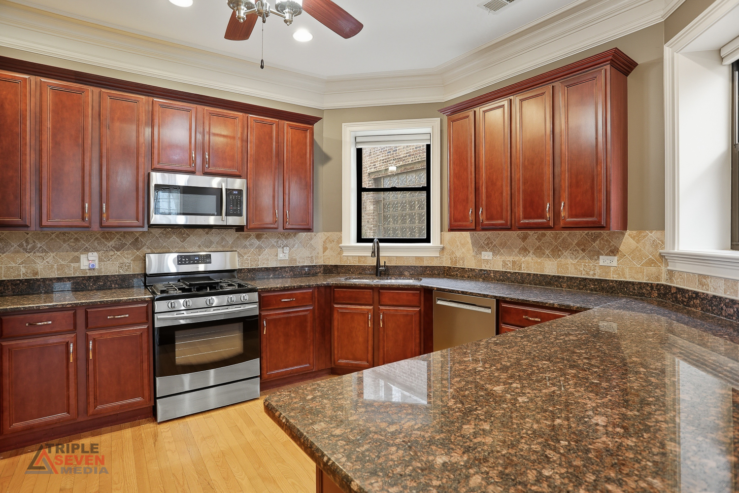5039 South Michigan Avenue, Unit 1S Chicago, IL 60615 - Photo 6 of 25 a kitchen with stainless steel appliances granite countertop wooden cabinets a stove top oven a sink and dishwasher