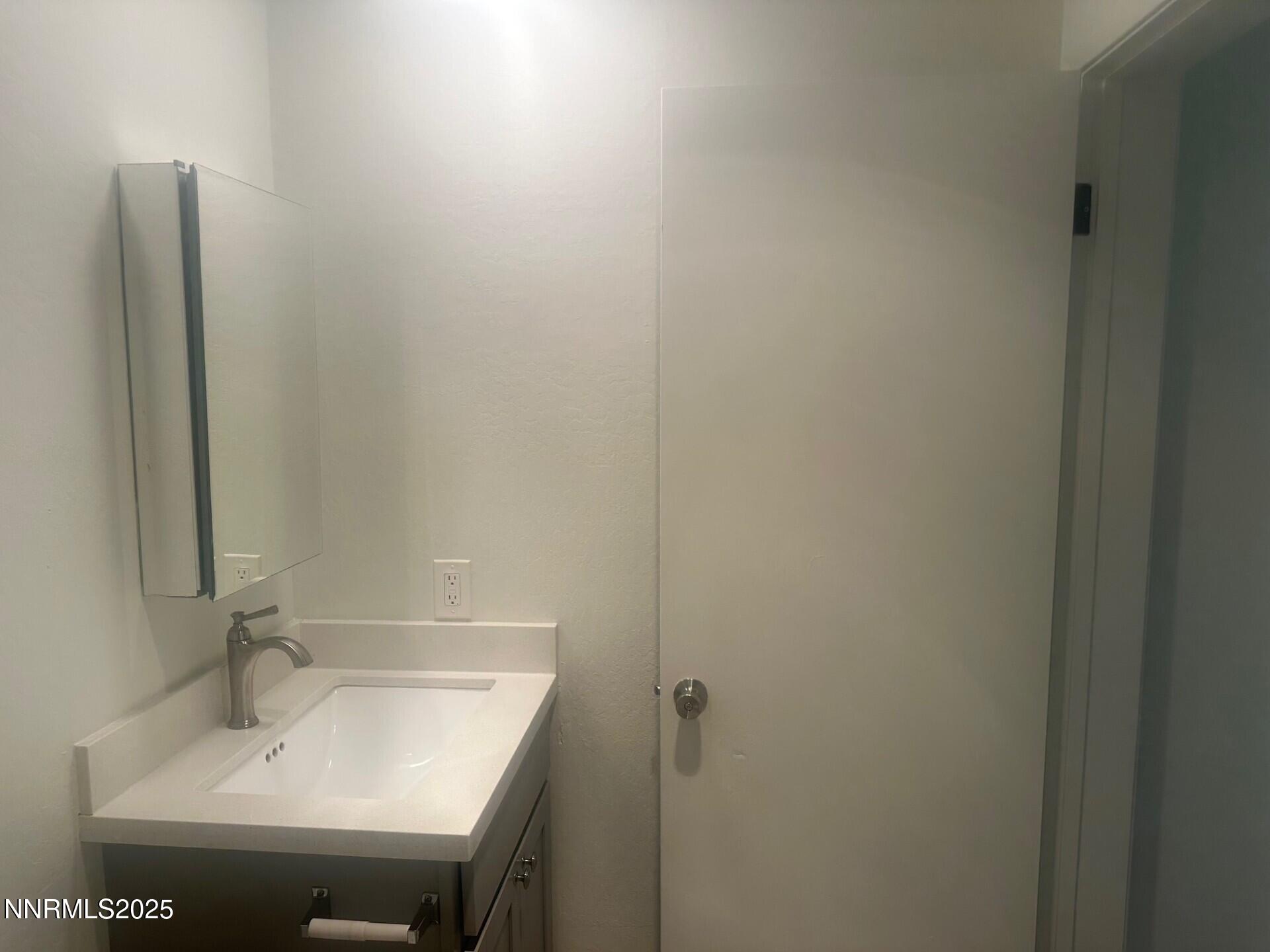 29 Park Street Reno, NV 89502 - Photo 11 of 17 a bathroom with a sink and mirror