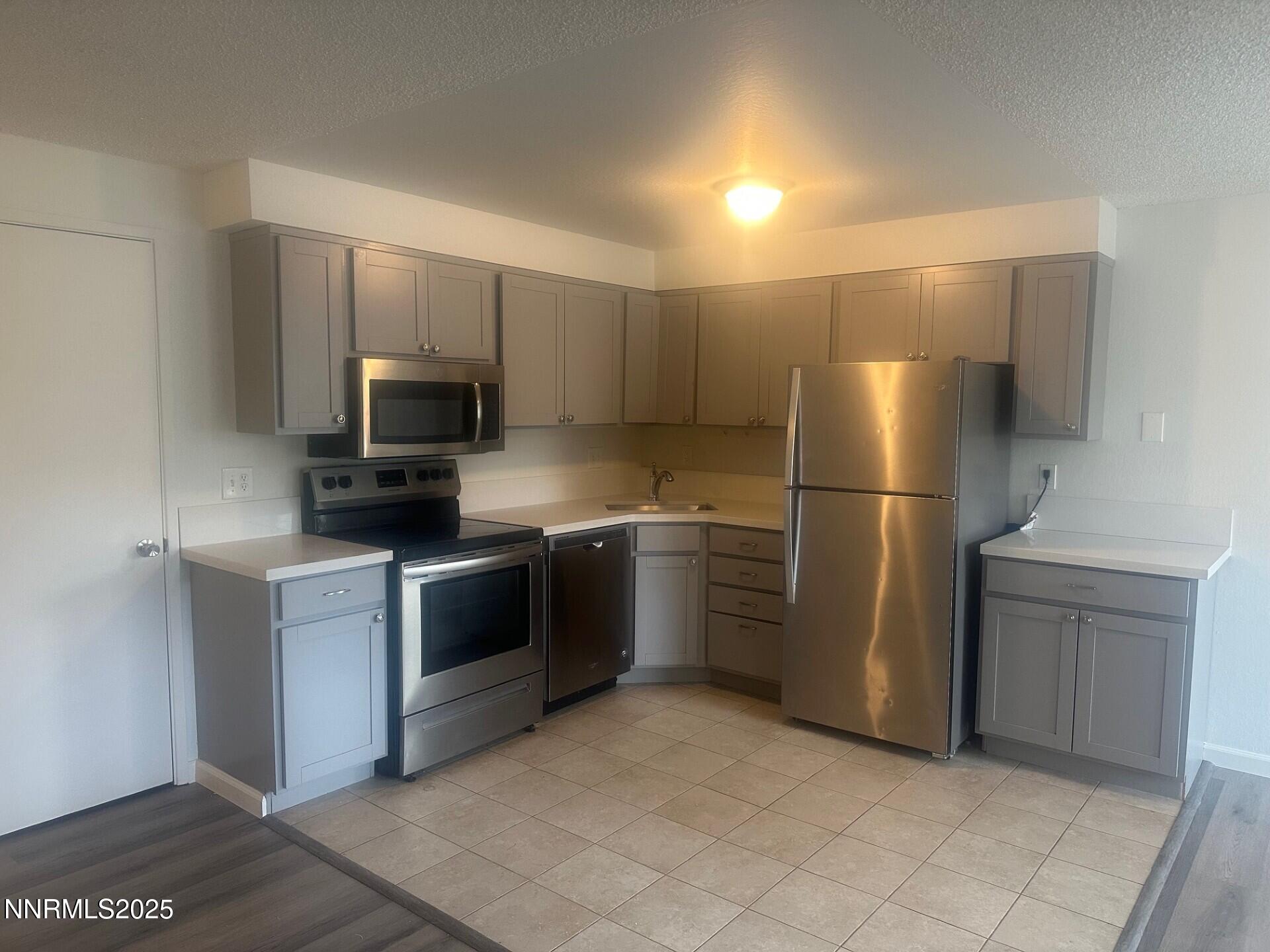 29 Park Street Reno, NV 89502 - Photo 5 of 17 a kitchen with a refrigerator stainless steel appliances and cabinets