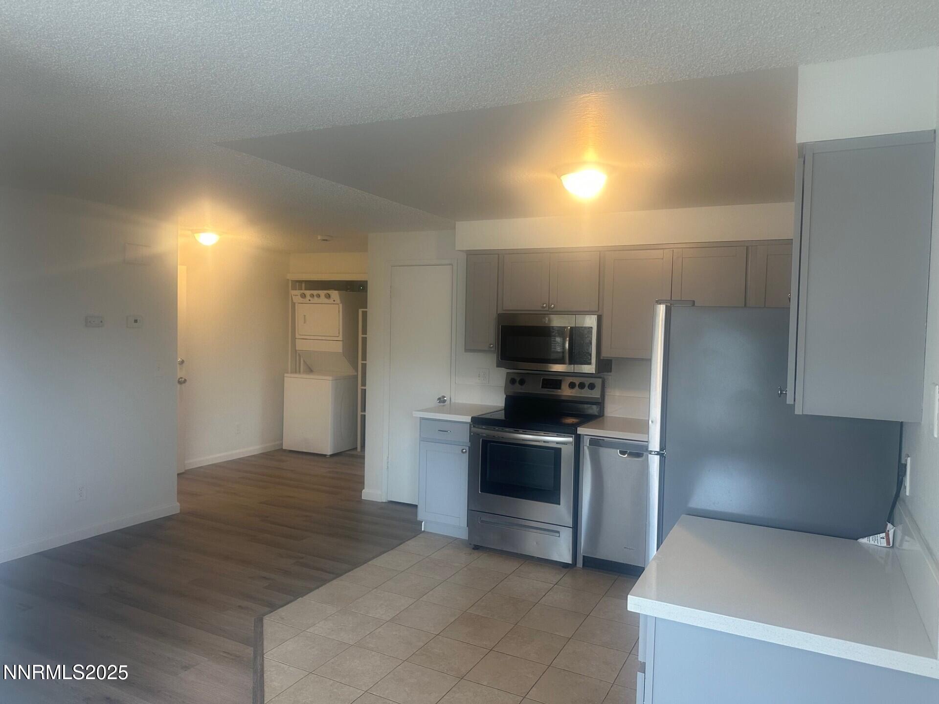 29 Park Street Reno, NV 89502 - Photo 6 of 17 a kitchen with granite countertop a refrigerator and a stove top oven