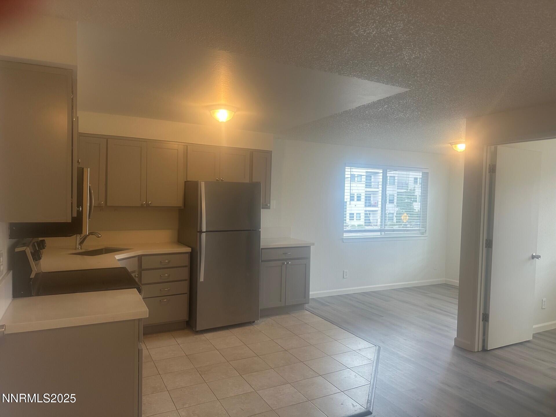 29 Park Street Reno, NV 89502 - Photo 7 of 17 a view of a kitchen with a sink dishwasher and a refrigerator