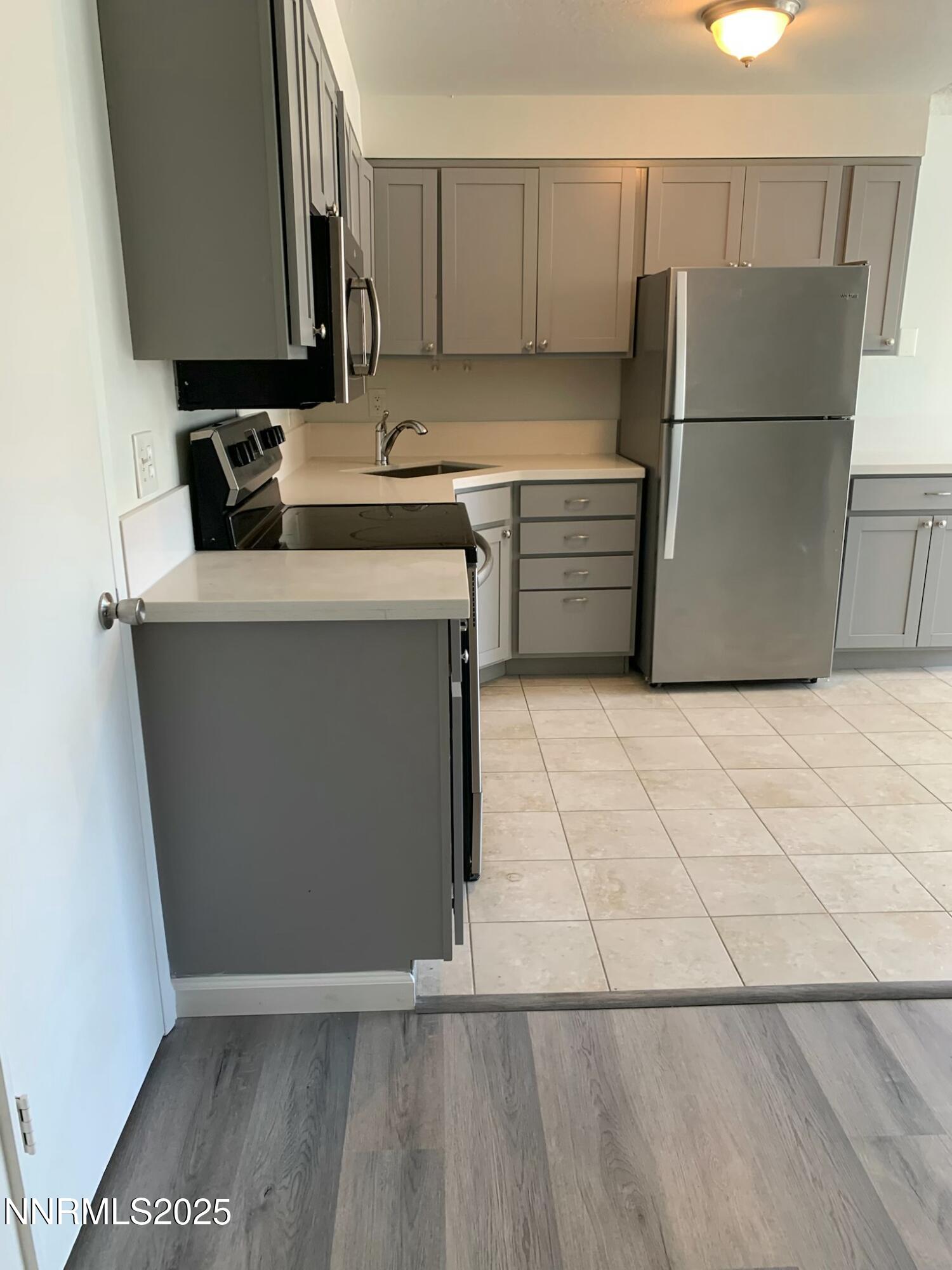 29 Park Street Reno, NV 89502 - Photo 9 of 17 a kitchen with a sink a refrigerator and a stove