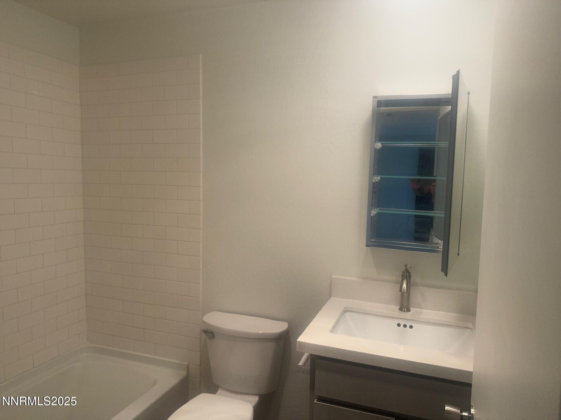 29 Park Street Reno, NV 89502 - Photo 10 of 17 a bathroom with a sink a toilet and a mirror