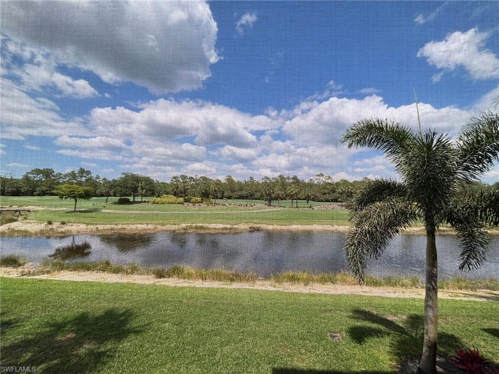 10341 Heritage Bay Boulevard, Unit 1922 Naples, FL 34120 - Photo 18 of 36 a view of a lake with a big yard