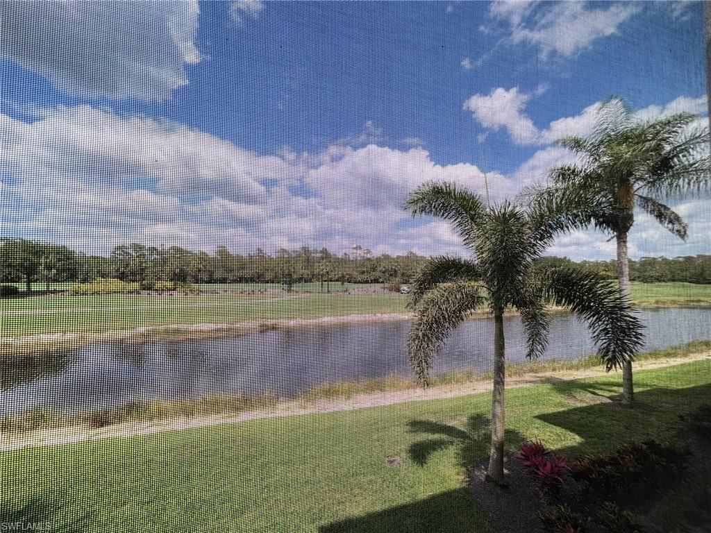 10341 Heritage Bay Boulevard, Unit 1922 Naples, FL 34120 - Photo 19 of 36 a view of a lake with a big yard