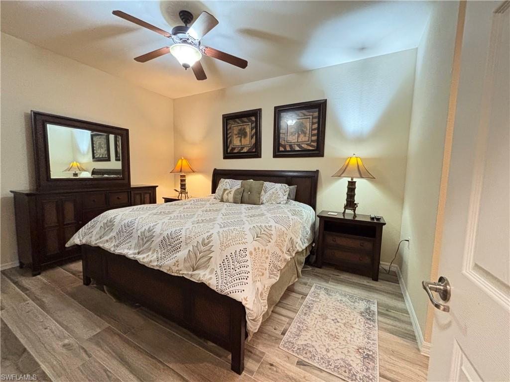 10341 Heritage Bay Boulevard, Unit 1922 Naples, FL 34120 - Photo 10 of 36 a bedroom with a bed and a chandelier