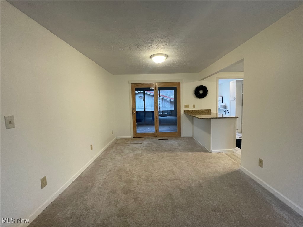 1984 Hebron Road St. Marys, WV 26170 - Photo 16 of 33 Carpeted empty room featuring a textured ceiling and baseboards