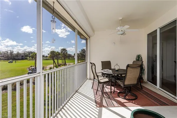 a view of a balcony with furniture and garden