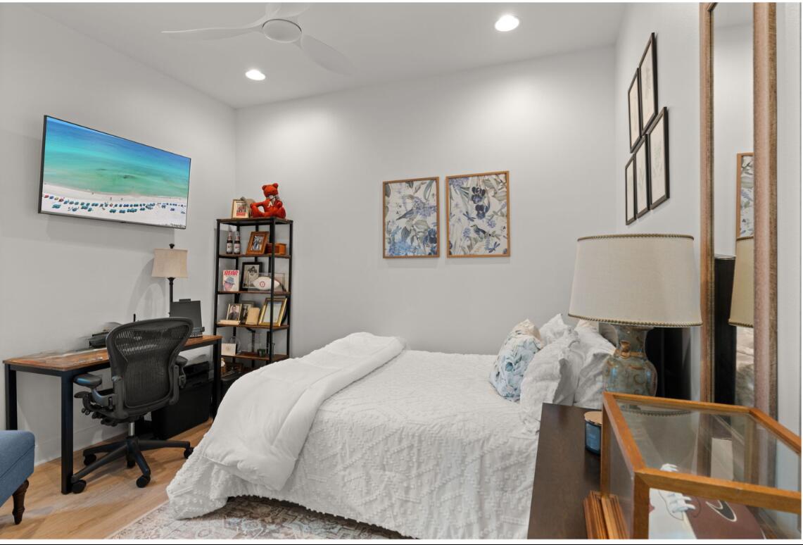 224 Carson Oaks Lane Miramar Beach, FL 32550 - Photo 16 of 27 a bedroom with a bed and a book shelf
