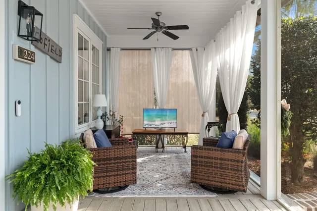a living room with furniture and a chandelier