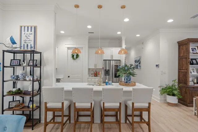 a dining room with furniture and potted plants