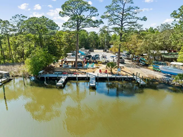 a view of a lake with boats and trees in the background