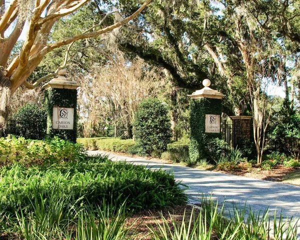 a front view of a house with a yard and fountain in middle