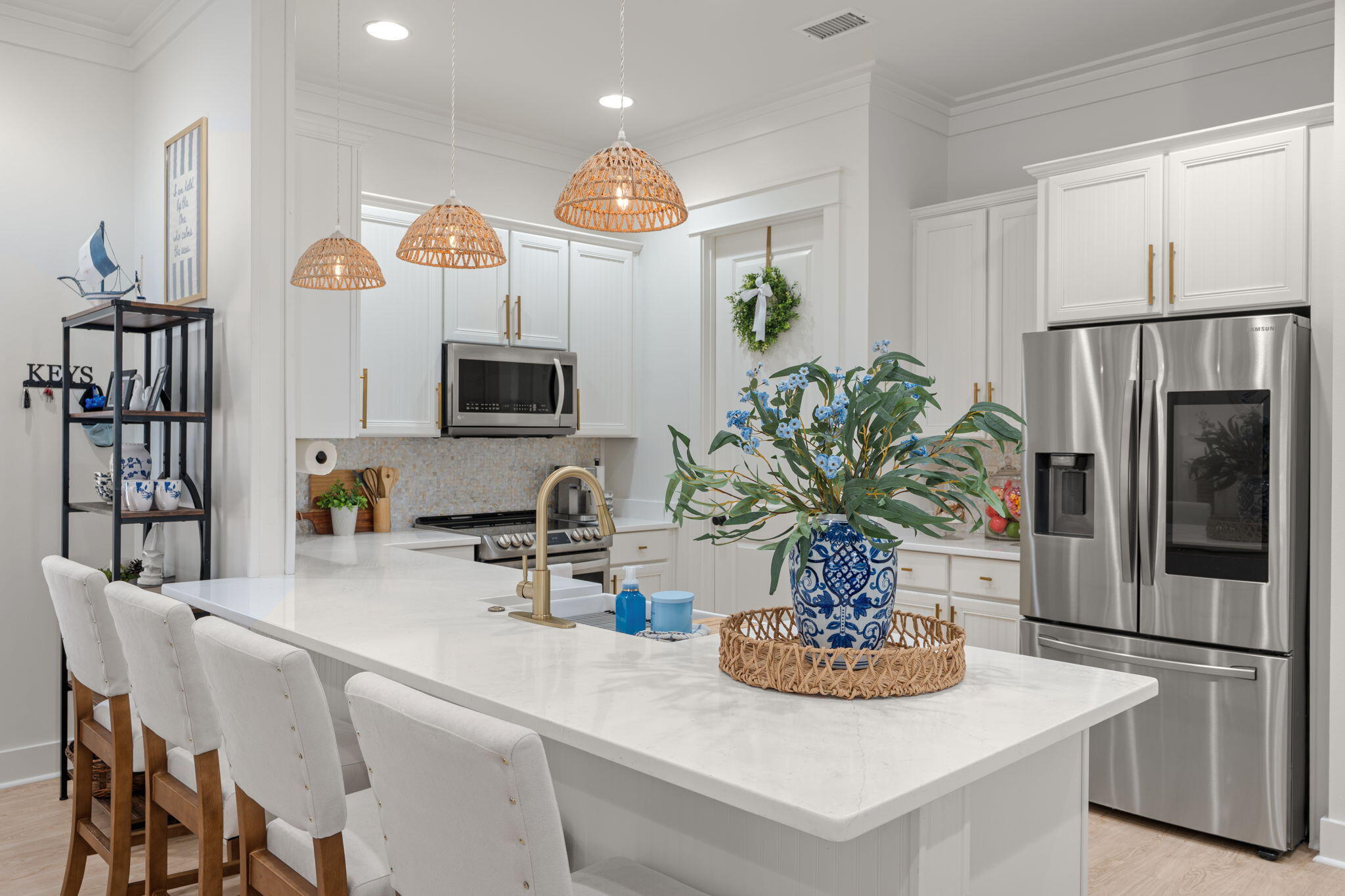 224 Carson Oaks Lane Miramar Beach, FL 32550 - Photo 3 of 27 a kitchen with stainless steel appliances a dining table a microwave a refrigerator and cabinets