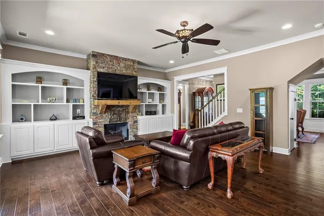 a living room with furniture a fireplace and a flat screen tv