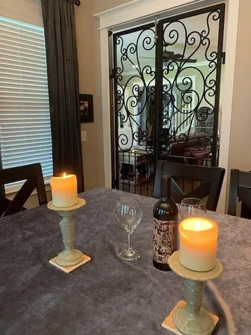 a lamp on table and chairs in a room