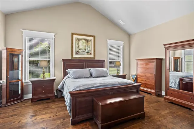 a bed sitting in a bedroom next to a window with a dresser