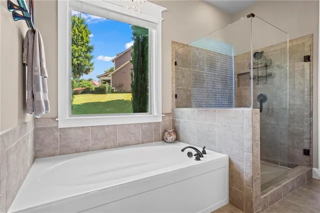 a bathroom with a bathtub and a shower