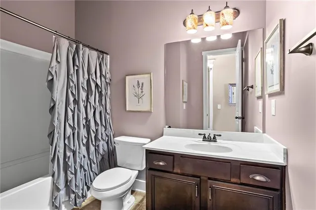 a bathroom with a sink a toilet and mirror