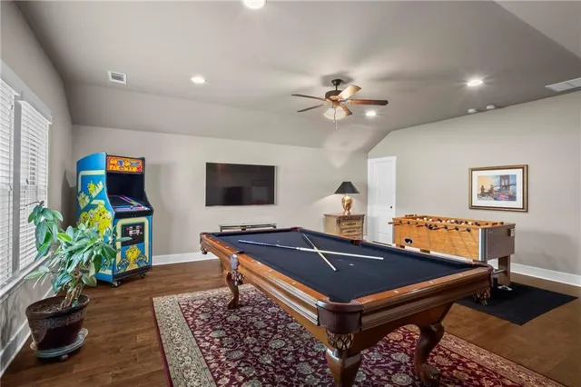 a living room with furniture a flat screen tv and a table