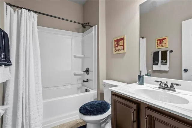 a bathroom with a granite countertop sink mirror toilet and bathtub