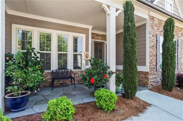 a view of a backyard with plants and outdoor seating