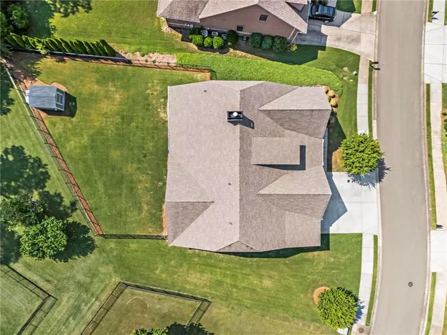 an aerial view of a house with a garden and swimming pool