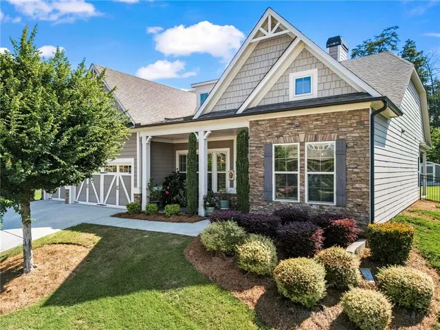 a view of a brick house with a yard