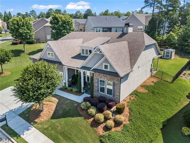 an aerial view of a house with a yard table and chairs