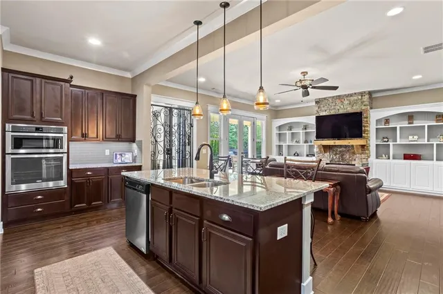 a kitchen with sink stove and refrigerator