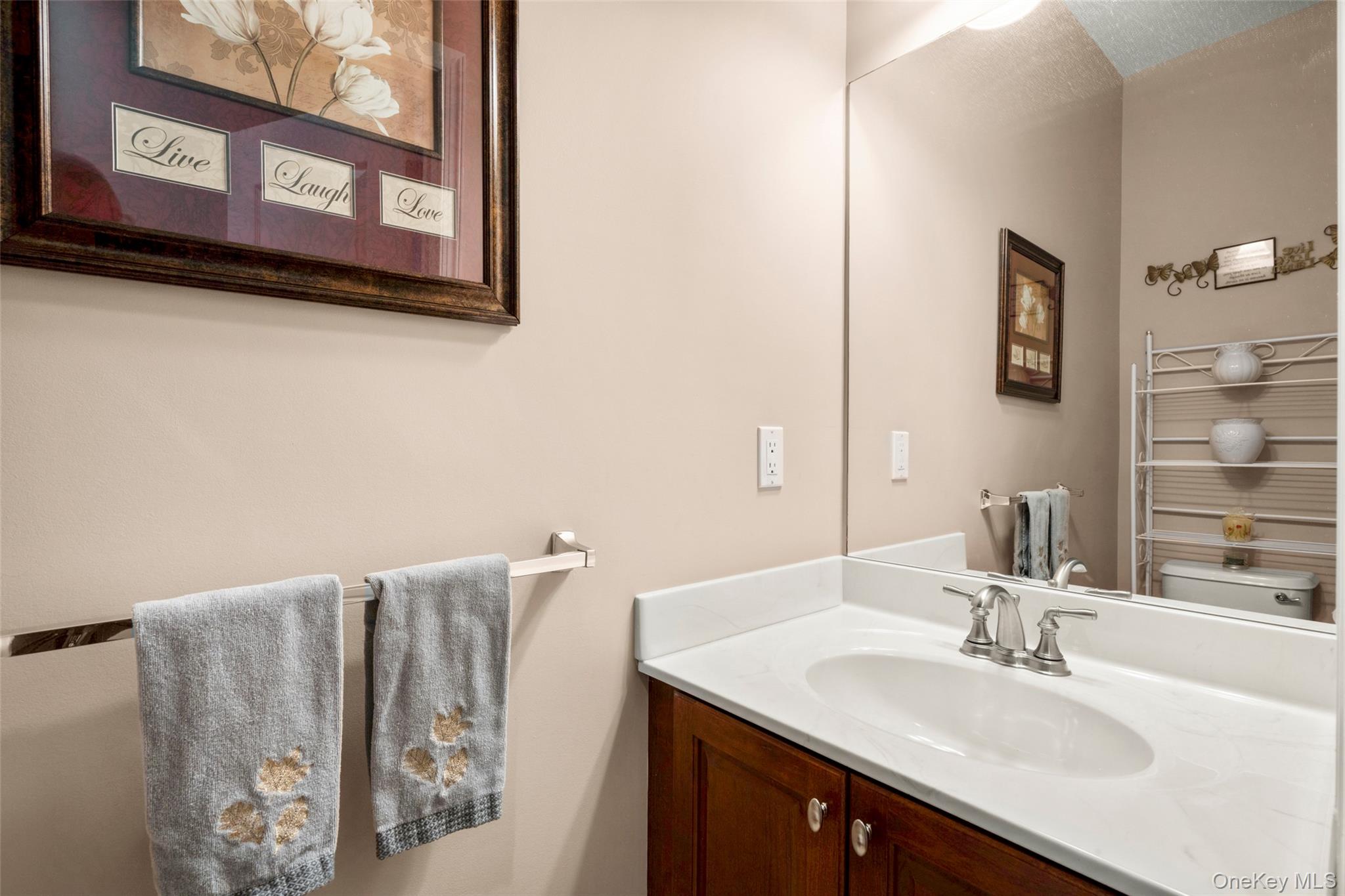 653 Creekside Lane Fishkill, NY 12524 - Photo 19 of 36 a bathroom with a sink and a mirror