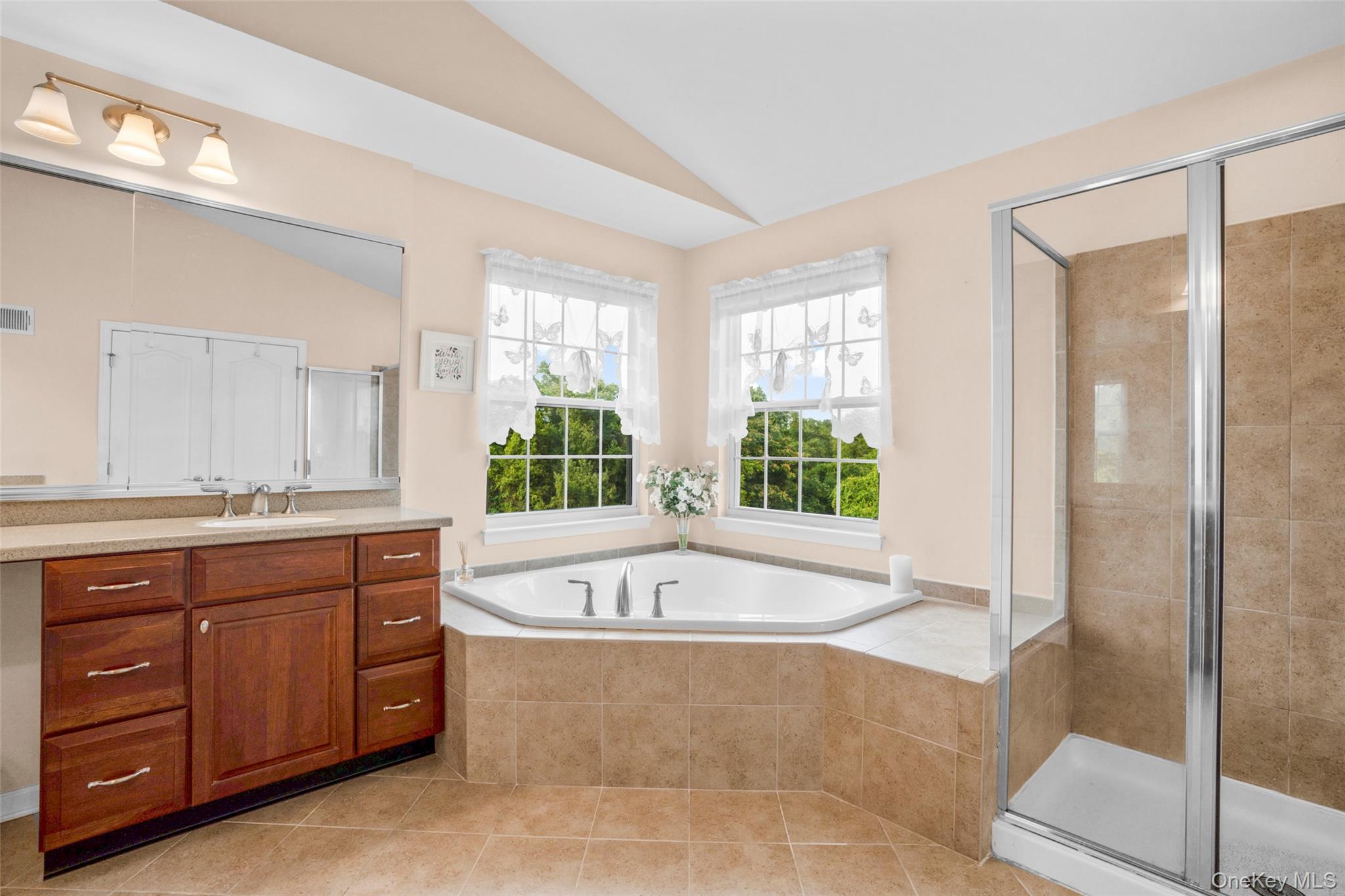653 Creekside Lane Fishkill, NY 12524 - Photo 23 of 36 a spacious bathroom with a tub sink and mirror