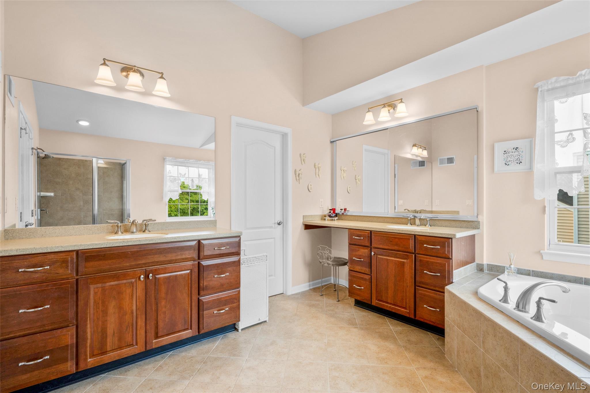 653 Creekside Lane Fishkill, NY 12524 - Photo 25 of 36 a spacious bathroom with a granite countertop tub sink and mirror