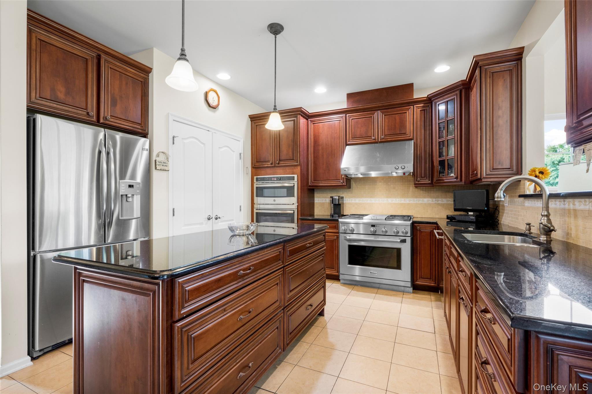 653 Creekside Lane Fishkill, NY 12524 - Photo 6 of 36 a kitchen with stainless steel appliances granite countertop a sink a stove and a refrigerator