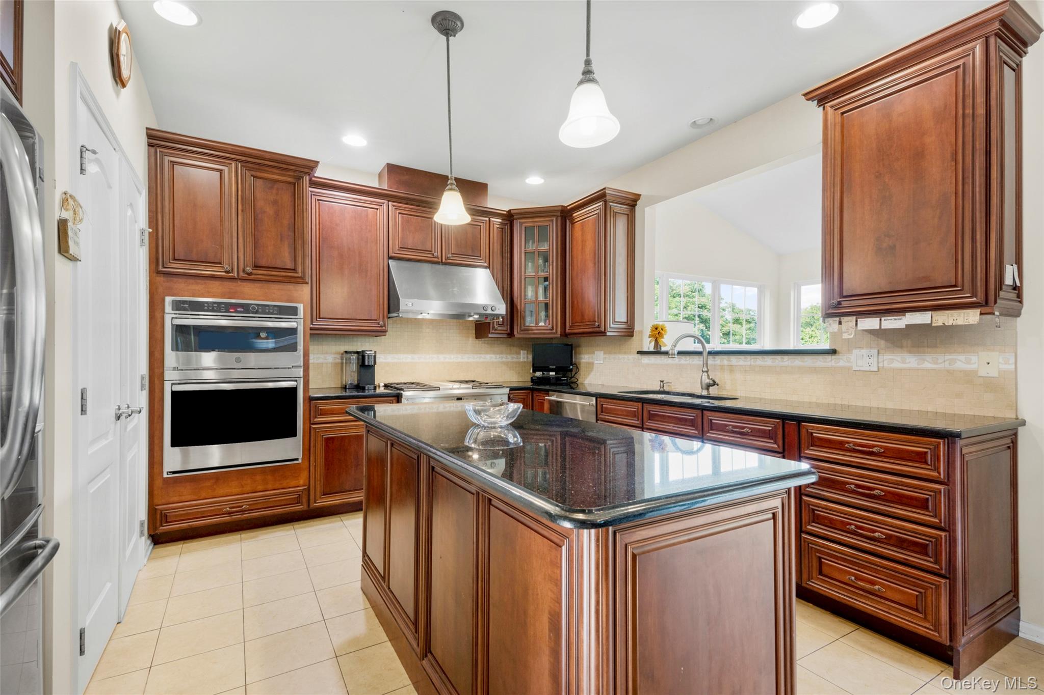 653 Creekside Lane Fishkill, NY 12524 - Photo 8 of 36 a kitchen with stainless steel appliances granite countertop a sink a stove and a refrigerator