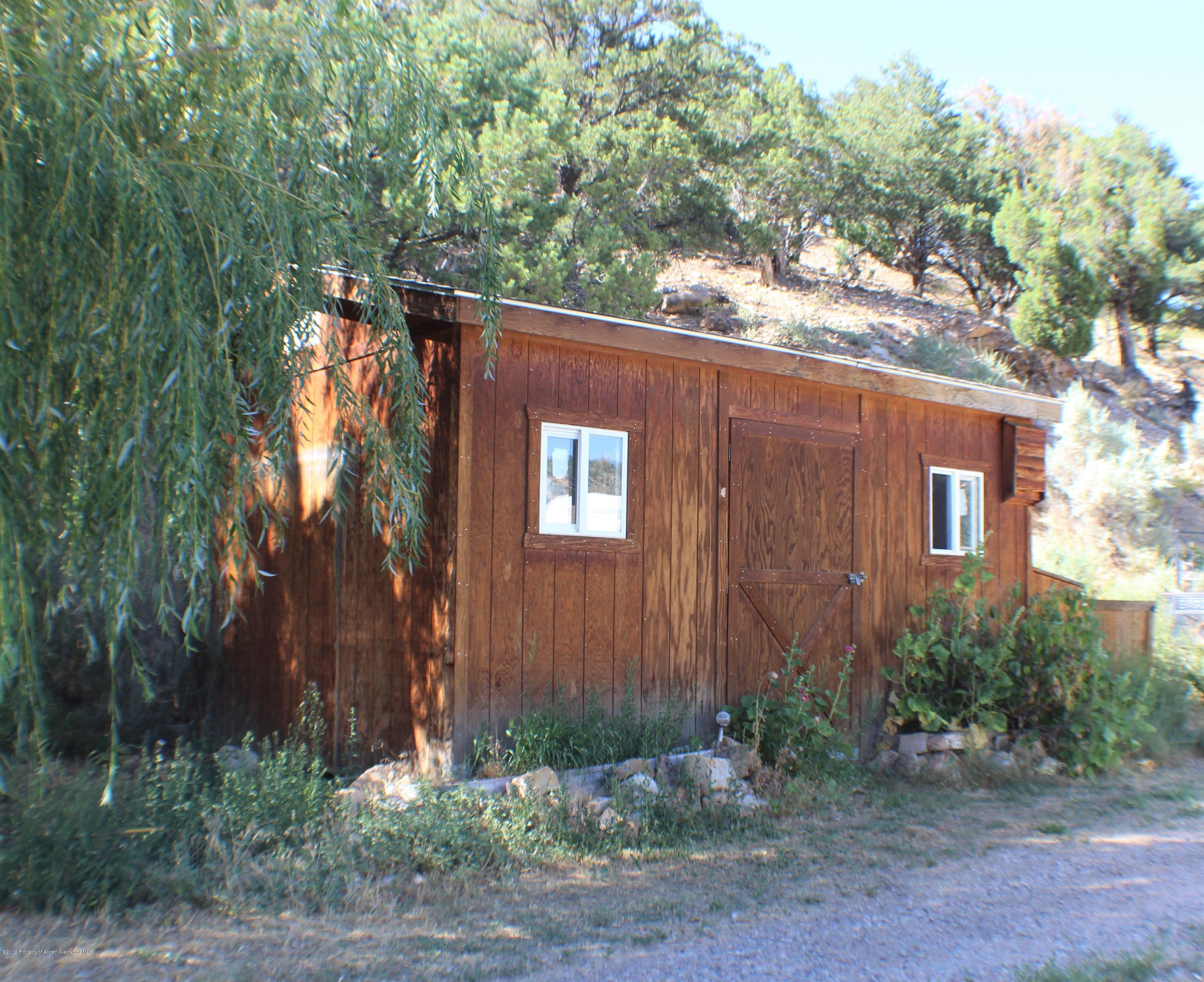 1521 County Road 252 Rifle, CO 81650 - Photo 3 of 24 a view of a house with a backyard