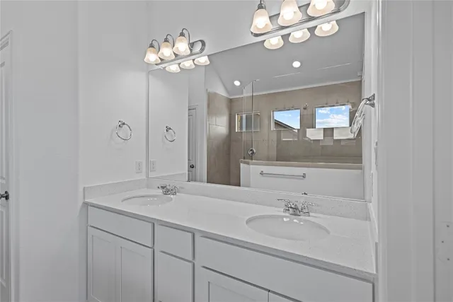 a bathroom with a double vanity sink and a mirror