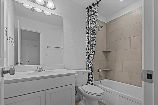 a view of an empty room with closet and a window