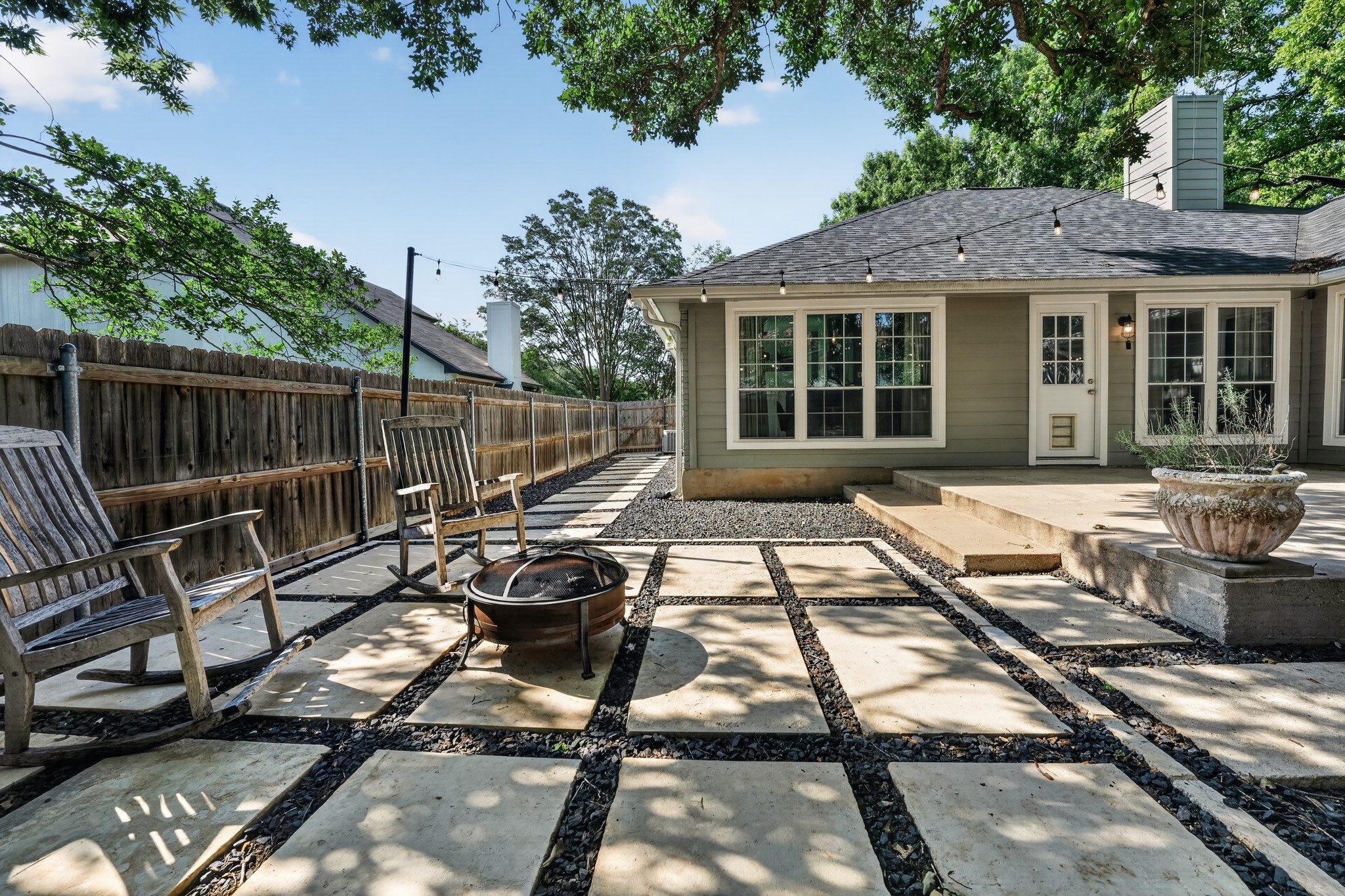 1811 Old Mill Road Cedar Park, TX 78613 - Photo 34 of 39 An inviting backyard patio features concrete pavers, a fire pit, and ample space for relaxation.