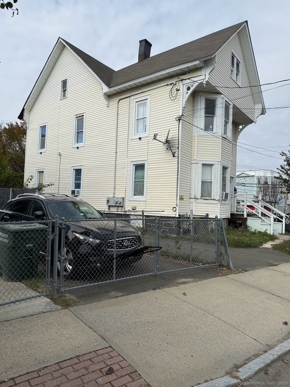 a view of a white house with a outdoor space