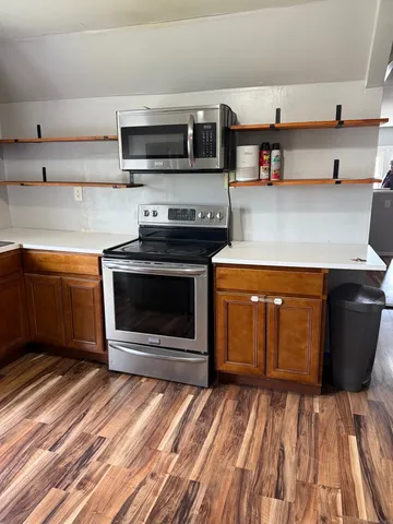a kitchen with stainless steel appliances granite countertop a stove and a microwave