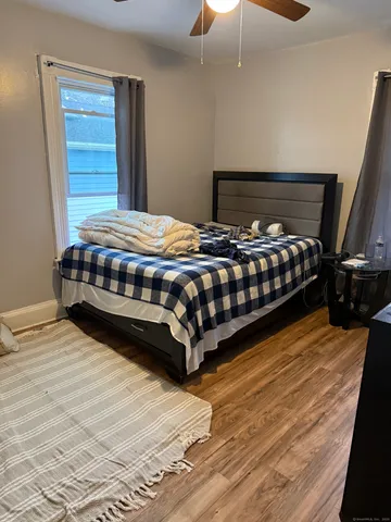 a bedroom with a bed and window