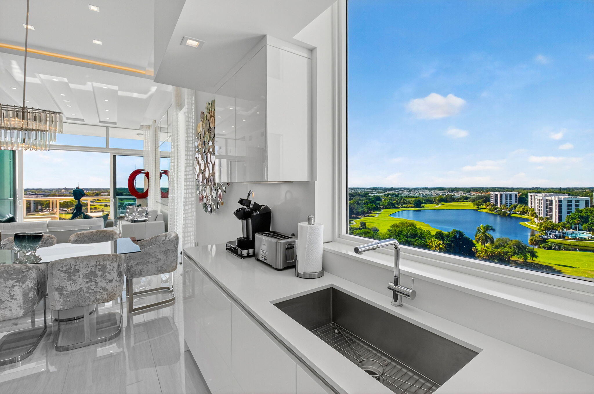 20155 Boca W Drive, Unit PHB904 Boca Raton, FL 33434 - Photo 13 of 50 a kitchen with a sink and breakfast area