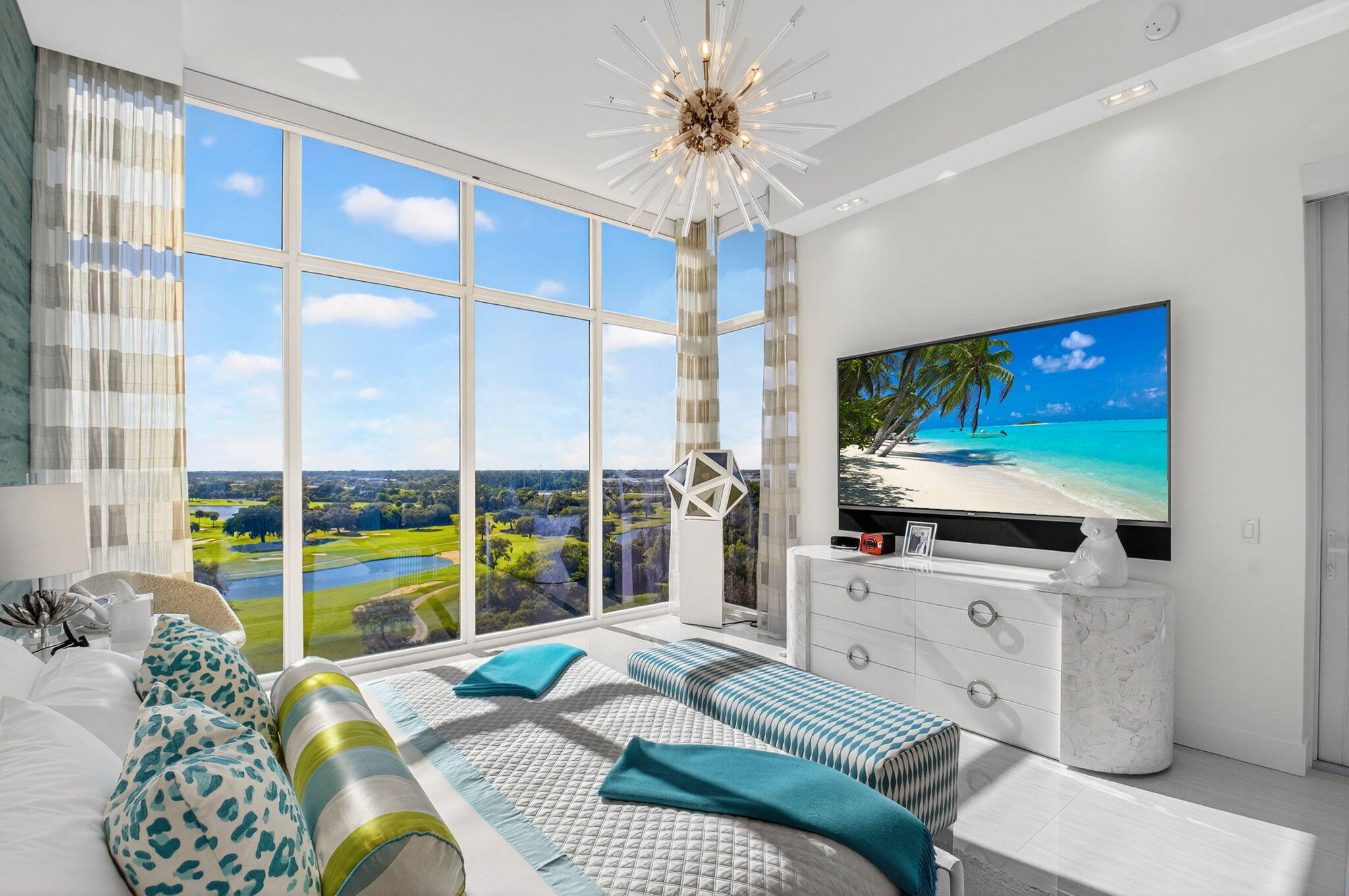 20155 Boca W Drive, Unit PHB904 Boca Raton, FL 33434 - Photo 17 of 50 a living room with furniture a flat screen tv and a floor to ceiling window