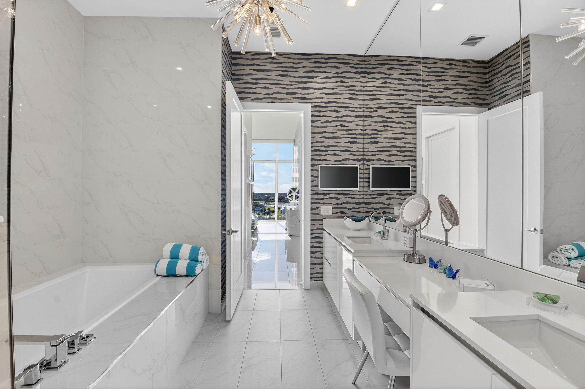 20155 Boca W Drive, Unit PHB904 Boca Raton, FL 33434 - Photo 18 of 50 a bathroom with a sink a bathtub a mirror a vanity and a shower