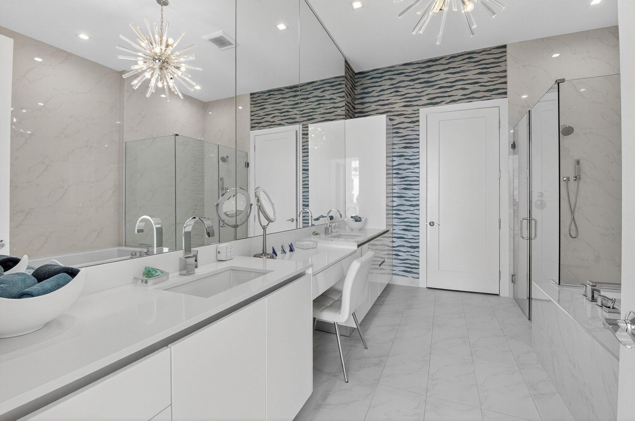 20155 Boca W Drive, Unit PHB904 Boca Raton, FL 33434 - Photo 19 of 50 a bathroom with a double vanity sink a mirror and a shower