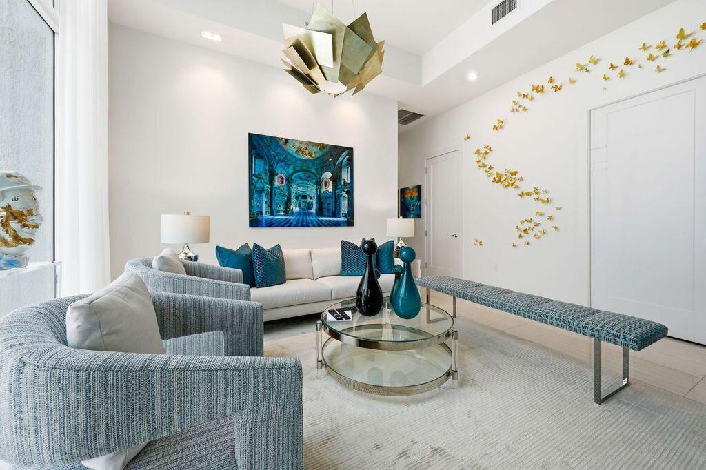 20155 Boca W Drive, Unit PHB904 Boca Raton, FL 33434 - Photo 28 of 50 a living room with furniture and wooden floor