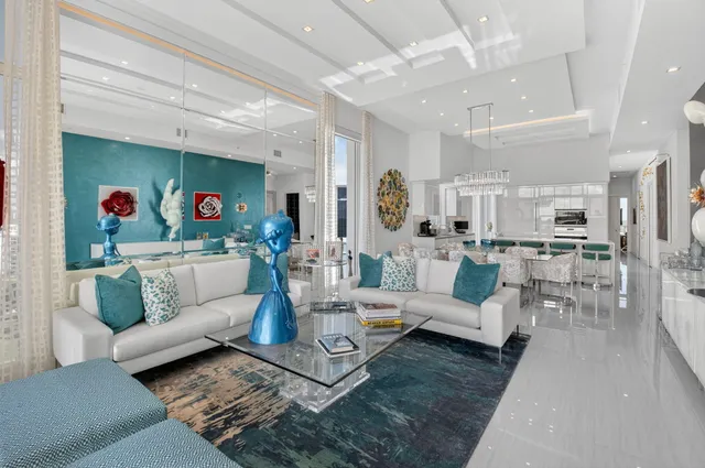 a living room with furniture and a view of kitchen