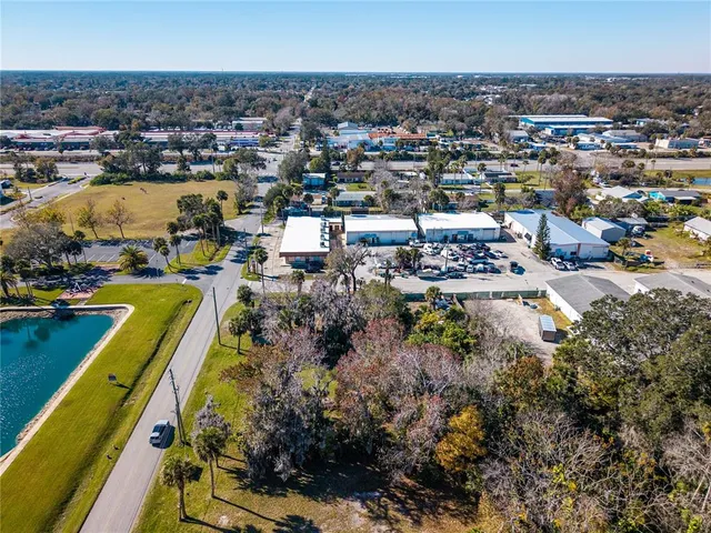 an aerial view of a house with a lake